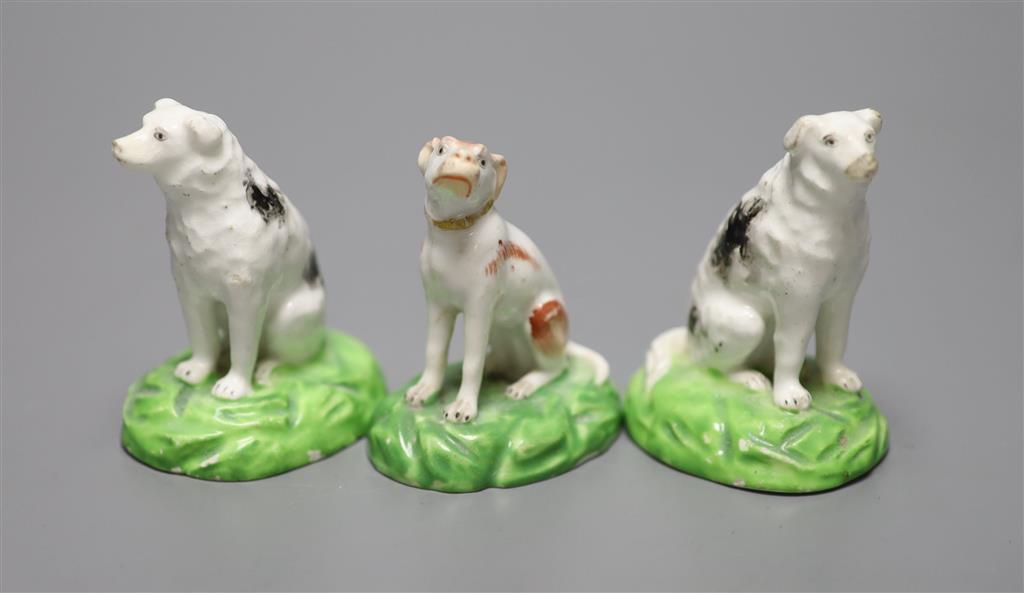 A pair of Staffordshire porcelain figures of seated dogs, height 6.5cm, and another, c.1830-50